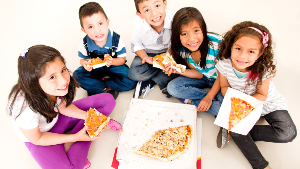 Young children eating pizza as meal 